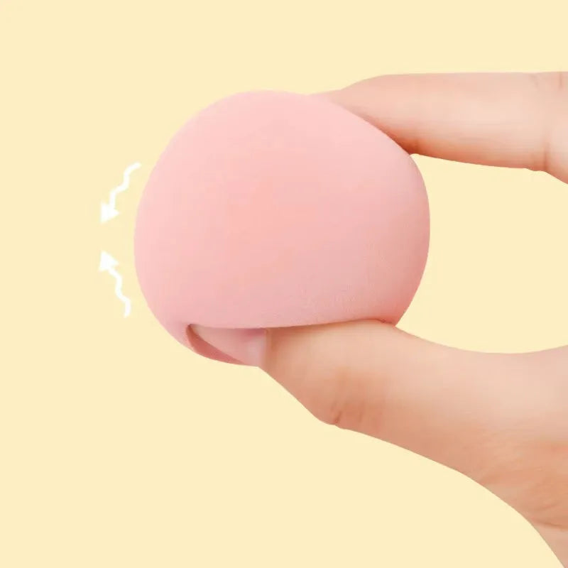 Assorted makeup sponges in seven shapes including pear and peach heart designs, 60x42mm, non-latex material