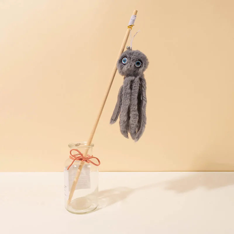 Grey furry octopus cat toy with eyes on a long stick for interactive indoor play with kittens.