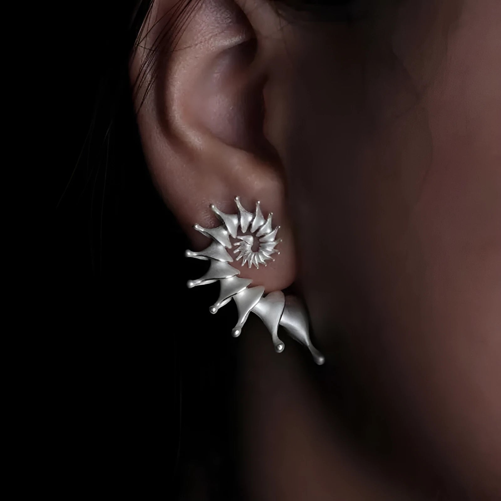 Three-dimensional matte conch stud earrings with irregular geometric shapes