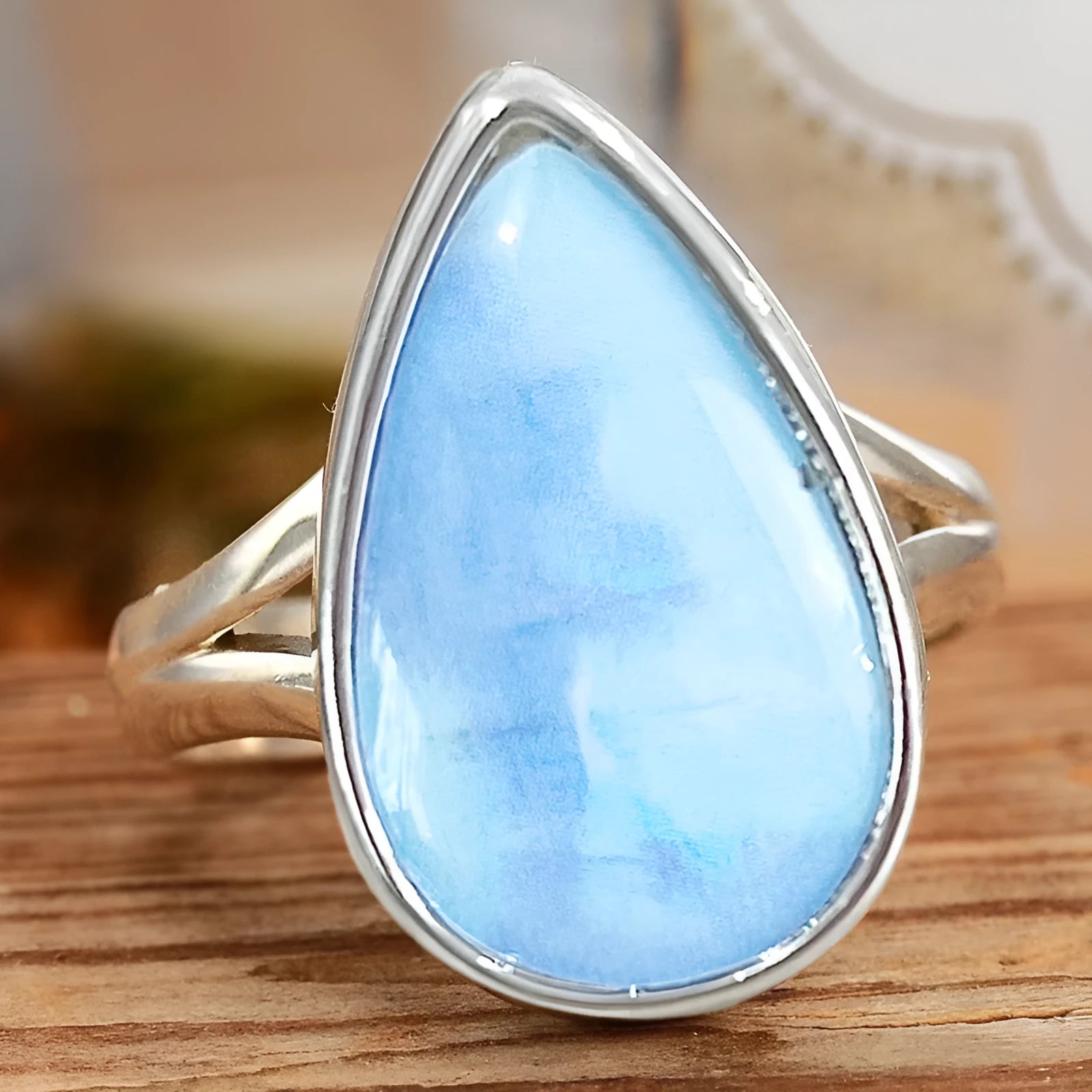 Women's copper water drop ring with white gold finish on white background