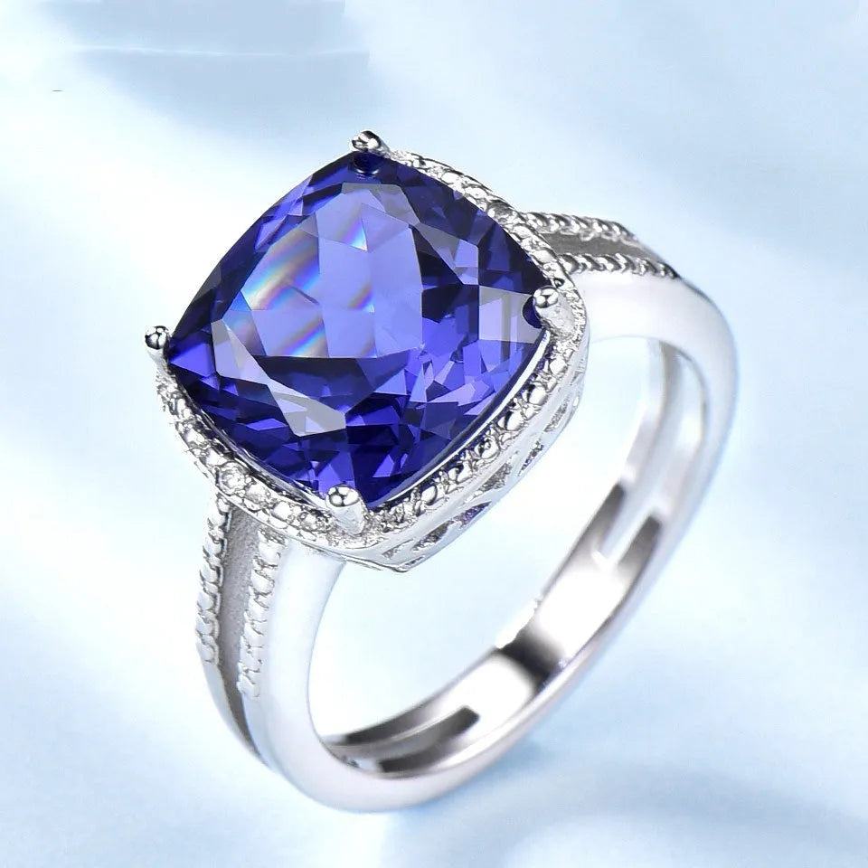 Women's sterling silver ring with blue tanzanite stone showing silver band and gemstone setting