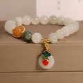 Close-up of a women's ice jade bracelet with a peace jade buckle and pearl decorative elements.