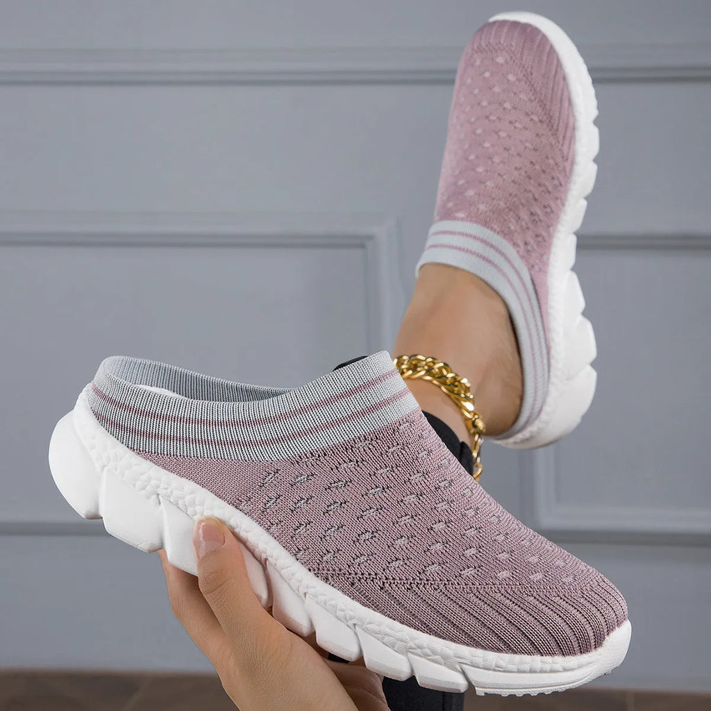 Women's black flyknit semi-slipper sock shoes with striped pattern and hollowed-out sewing lines on a lightweight sole.