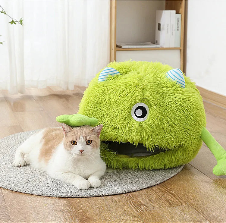 Round fluffy plush cat bed on a floor, showing its non-slip base, next to a resting cat.