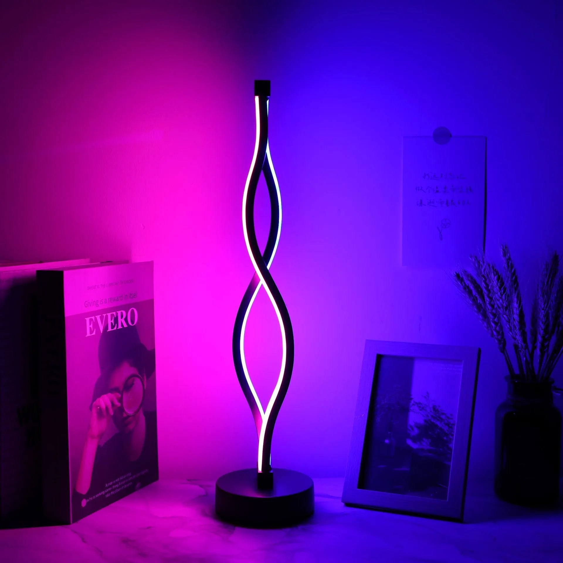 Black aluminium desk lamp with a touch dimming button showing three colour LED lights.