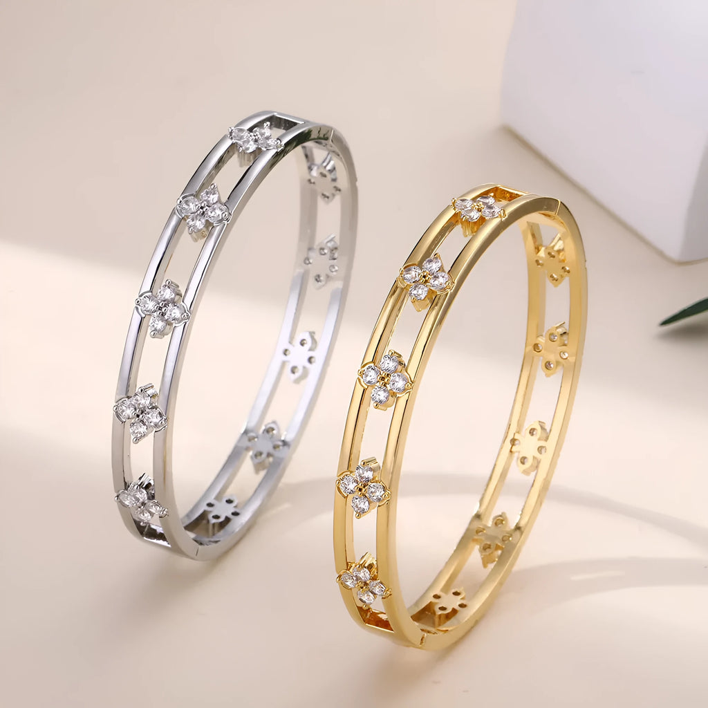 Gold or silver hollow women's bracelet with a four-leaf clover charm containing a white zircon stone.