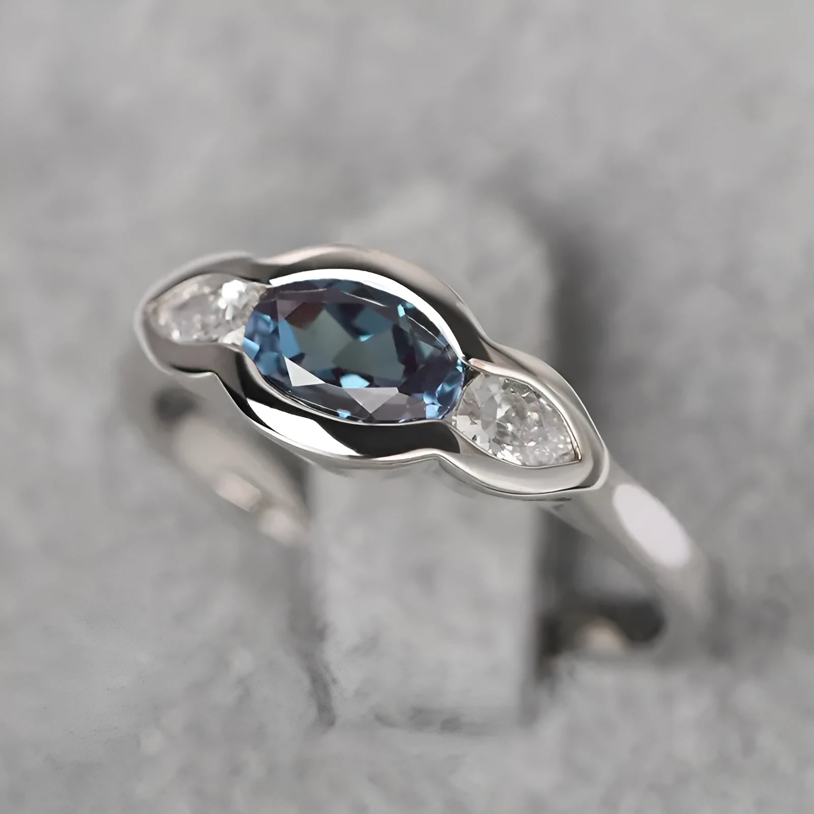 Women's geometric ellipse ring with inlaid zircon stones in white gold tone finish on finger