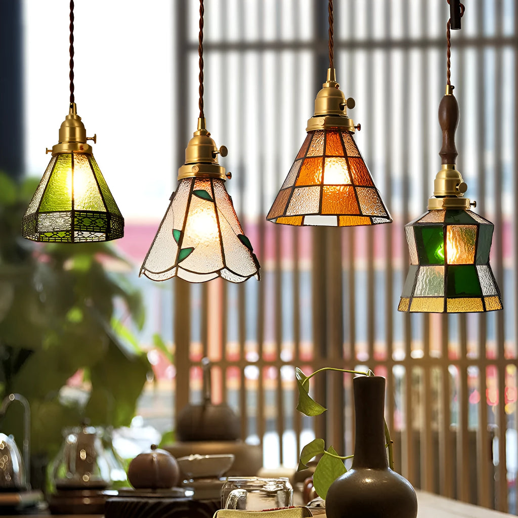 Retro brass and hand-blown glass chandelier with a hemp rope light line hanging from a ceiling.