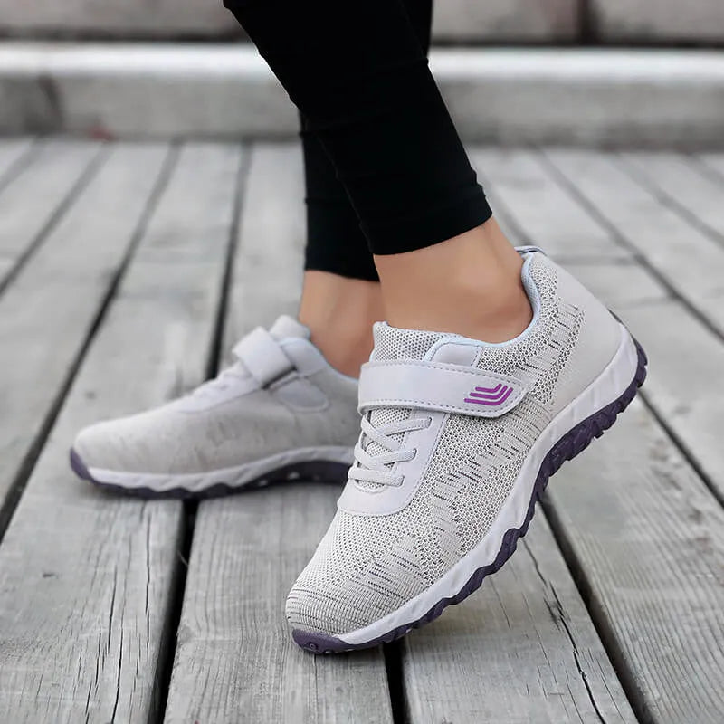Women's gray purple low-top casual shoes with velcro strap and wedge heel.