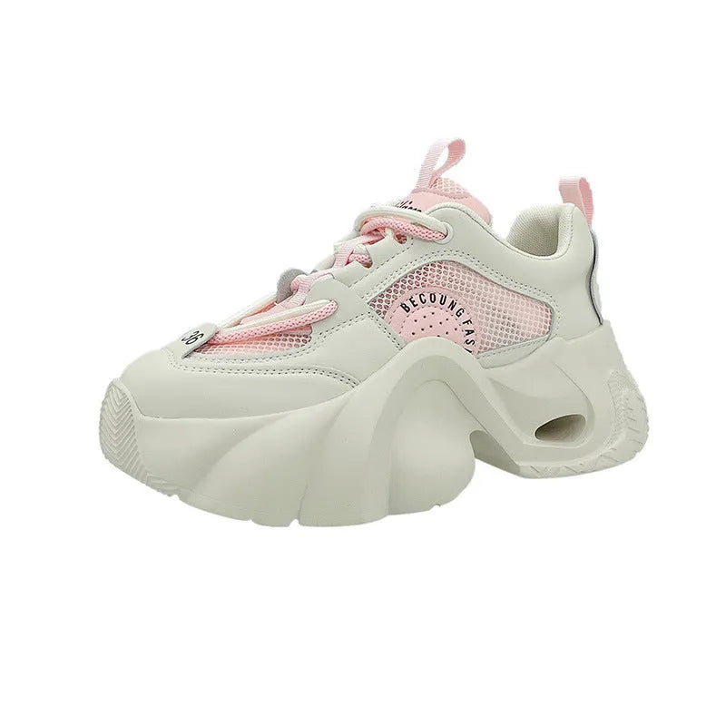 Women's beige casual sneakers with cross straps and a thick mid-height sole, shown from the side.