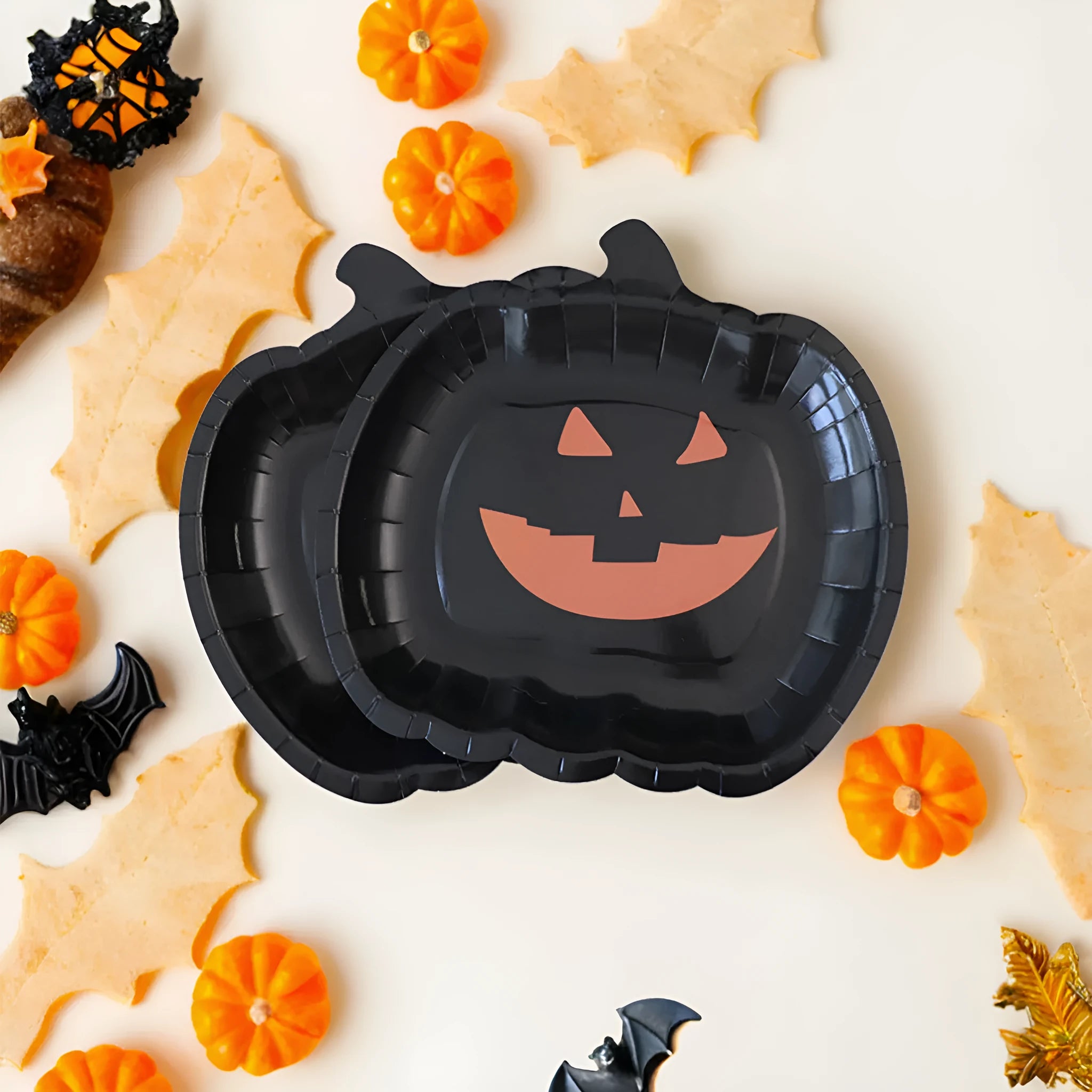 Black disposable paper plate with cute pumpkin design for Halloween, 9 inches in diameter.