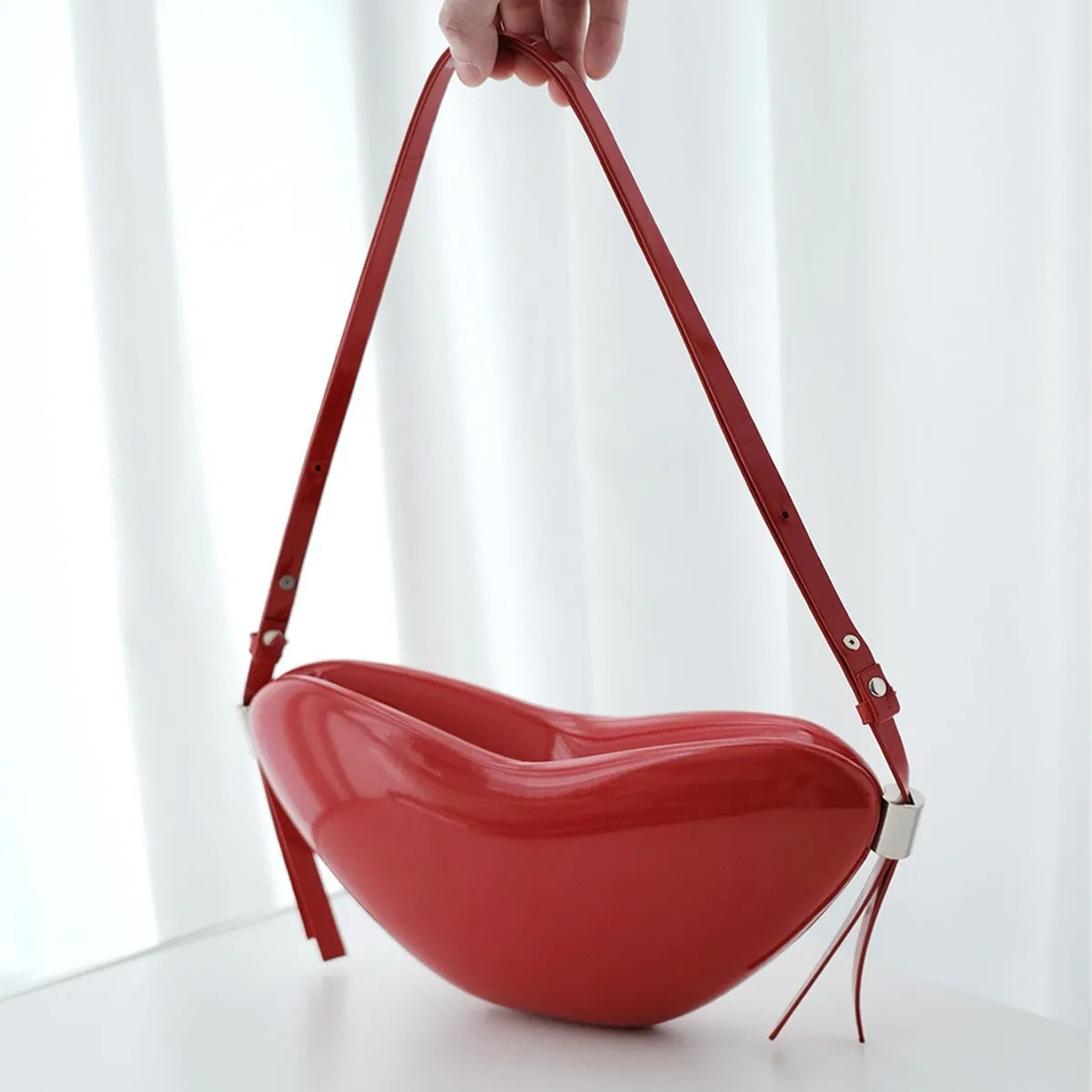 Red heart-shaped crossbody bag in PU material with single shoulder strap and exterior pocket