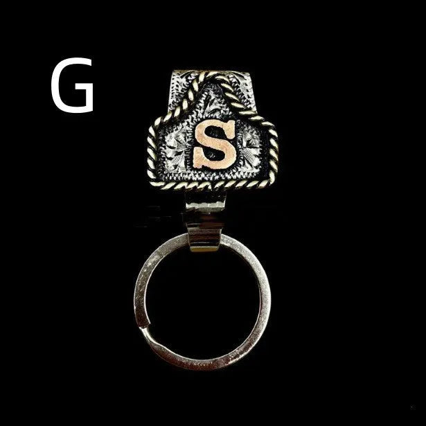 Handmade metal keychain with a cow tag charm in one of 26 available colour options.
