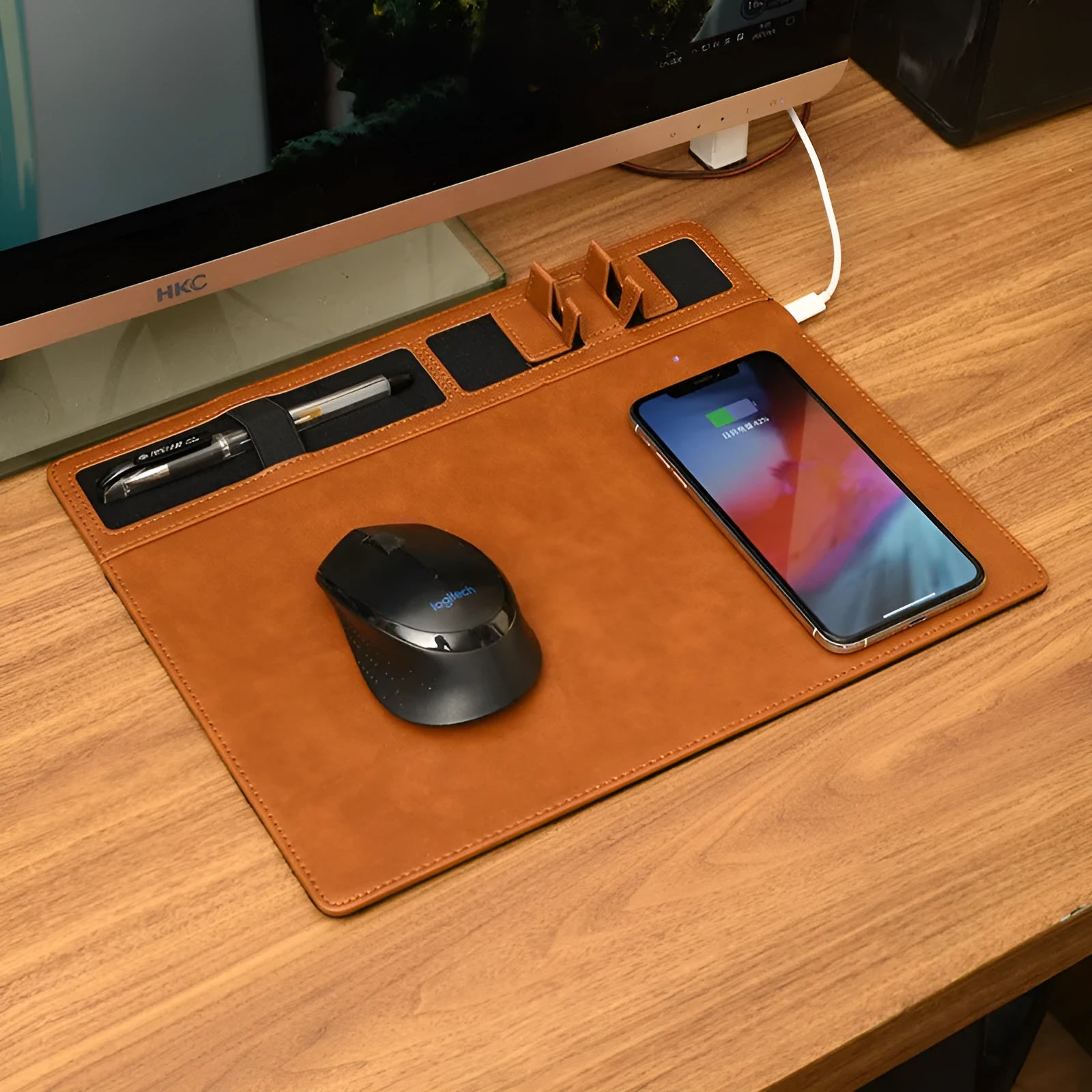 Pink wireless charging mouse pad with phone on charging area and mouse on PU leather surface