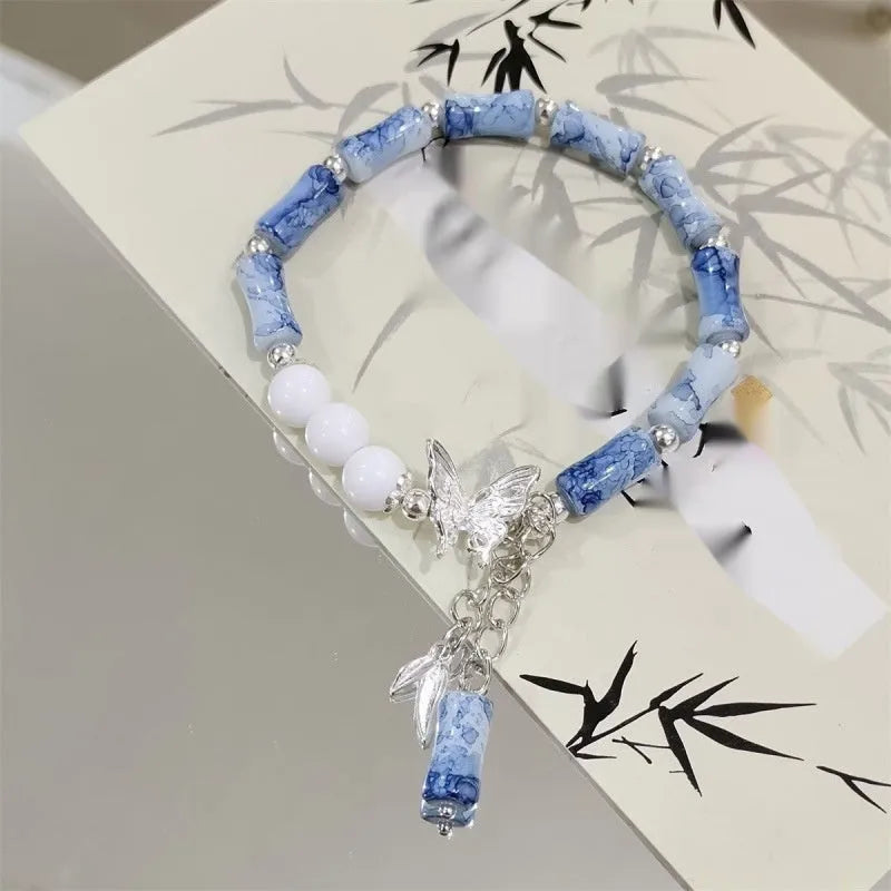 Chinese style glass bracelet with bamboo joint details in a red Lvzhu Duobao design.