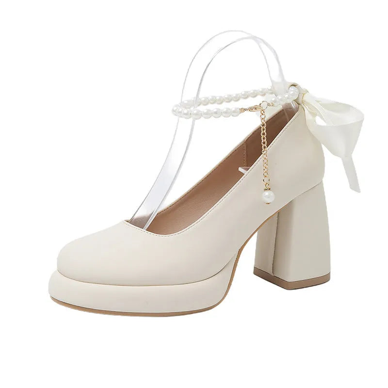 Women's beige Mary Jane shoes with a chunky heel, round toe, and a buckle fastening on the ankle strap.