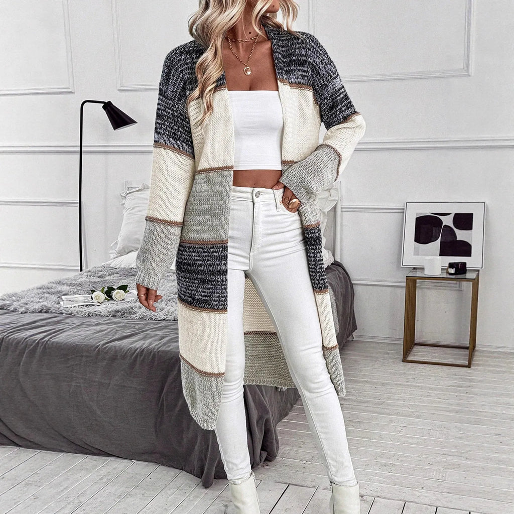Grey knitted long cardigan with loose fit and long sleeves on a woman
