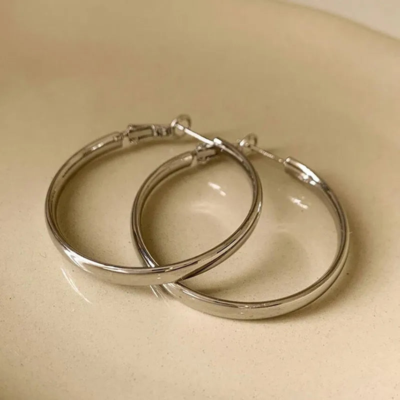 A pair of circular open-ring metal earrings in a gold or silver finish, measuring 40mm.