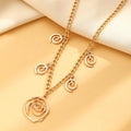 Spiral donut design alloy necklace, bracelet and earrings set in gold or silver electroplated finish.