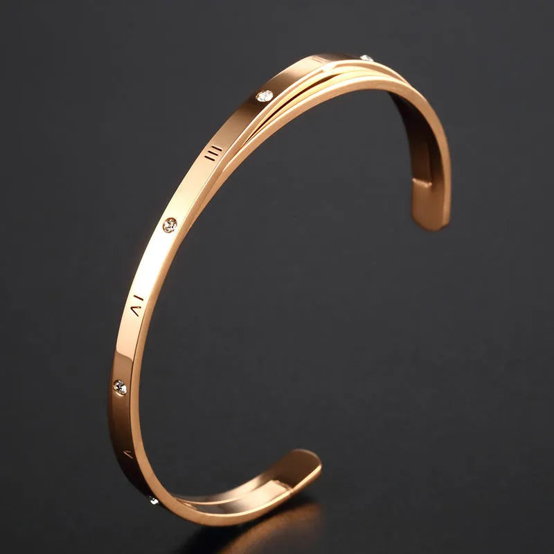 Open-ended adjustable bracelet with inlaid zircon detailing on love theme in rose gold steel colours