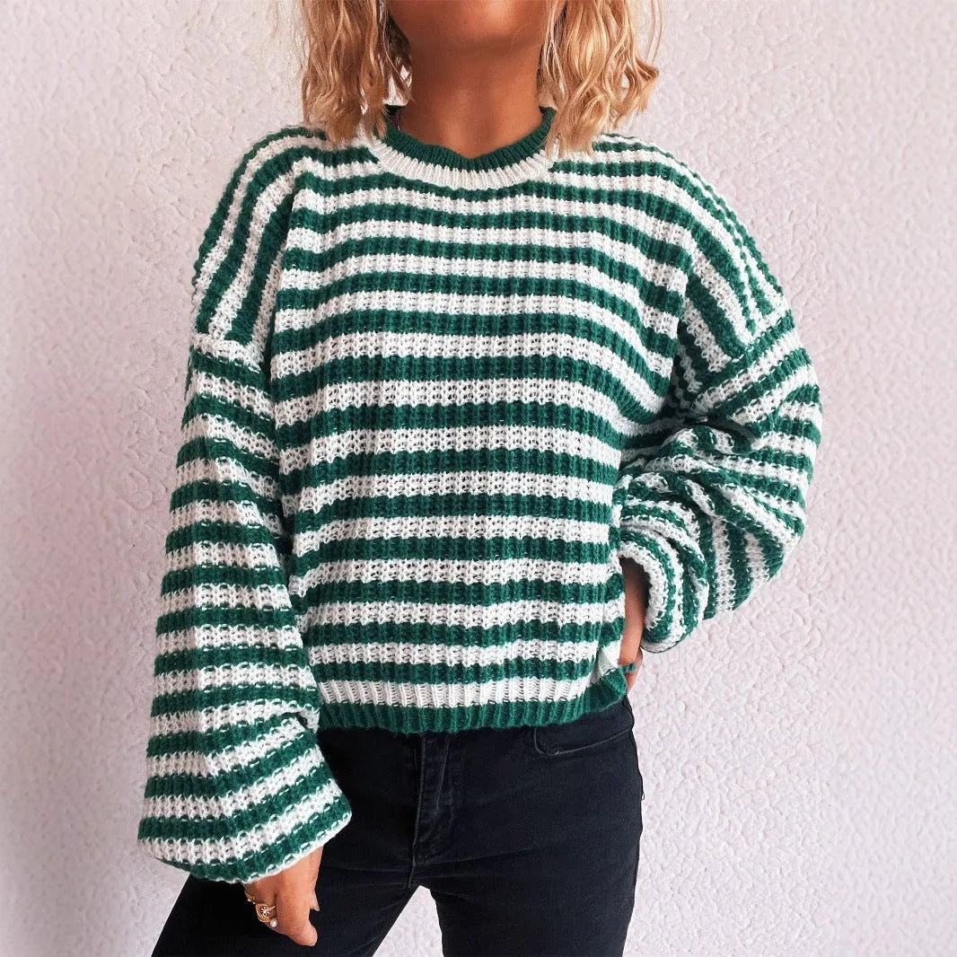 Woman wearing a vintage striped loose-fit pullover sweater in a khaki colour.