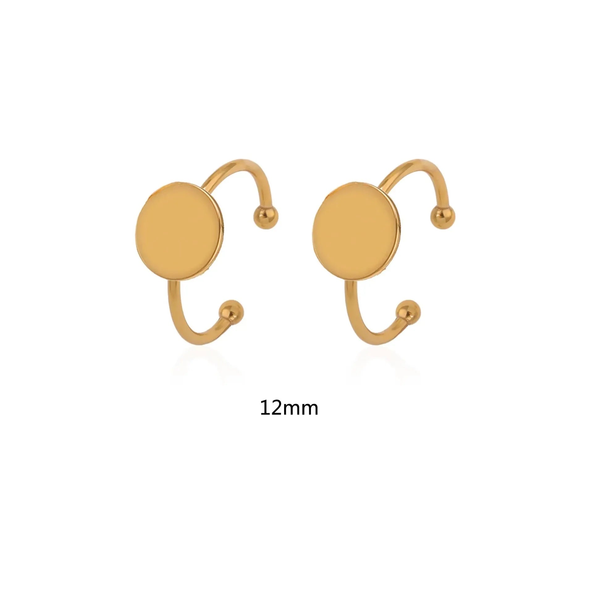 Assortment of golden stainless steel DIY jewellery settings in oval, heart, round, square, and rectangle shapes with totem pattern.