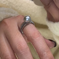 Geometric copper open finger ring with adjustable opening on a model's hand.