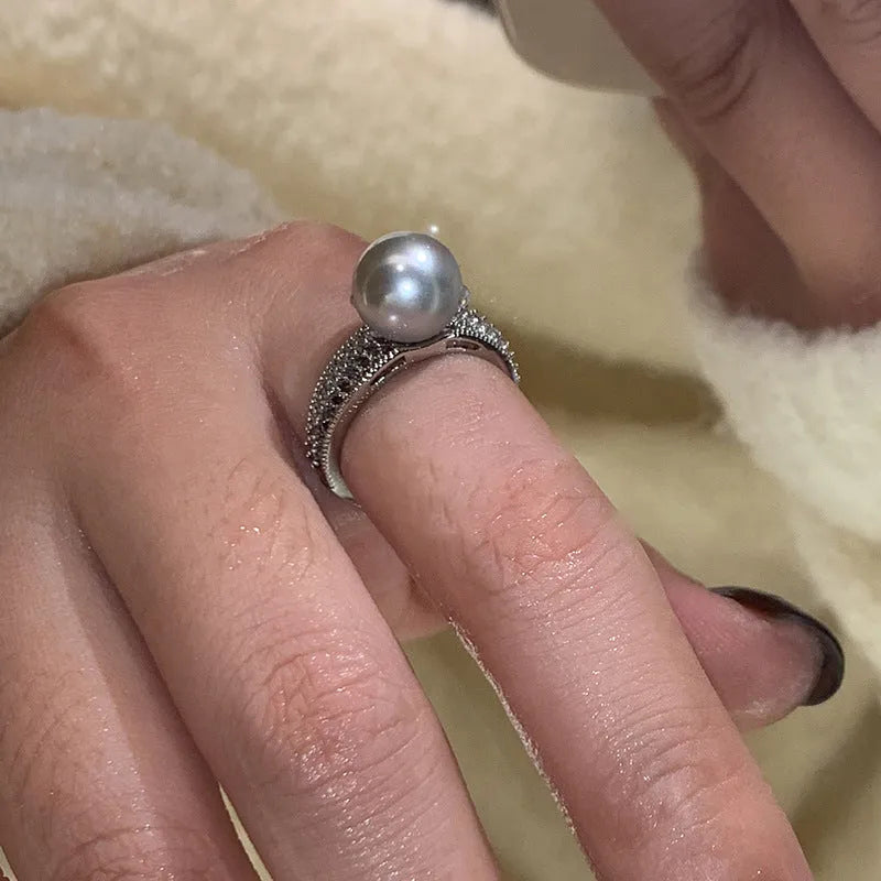 Geometric copper open finger ring with adjustable opening on a model's hand.