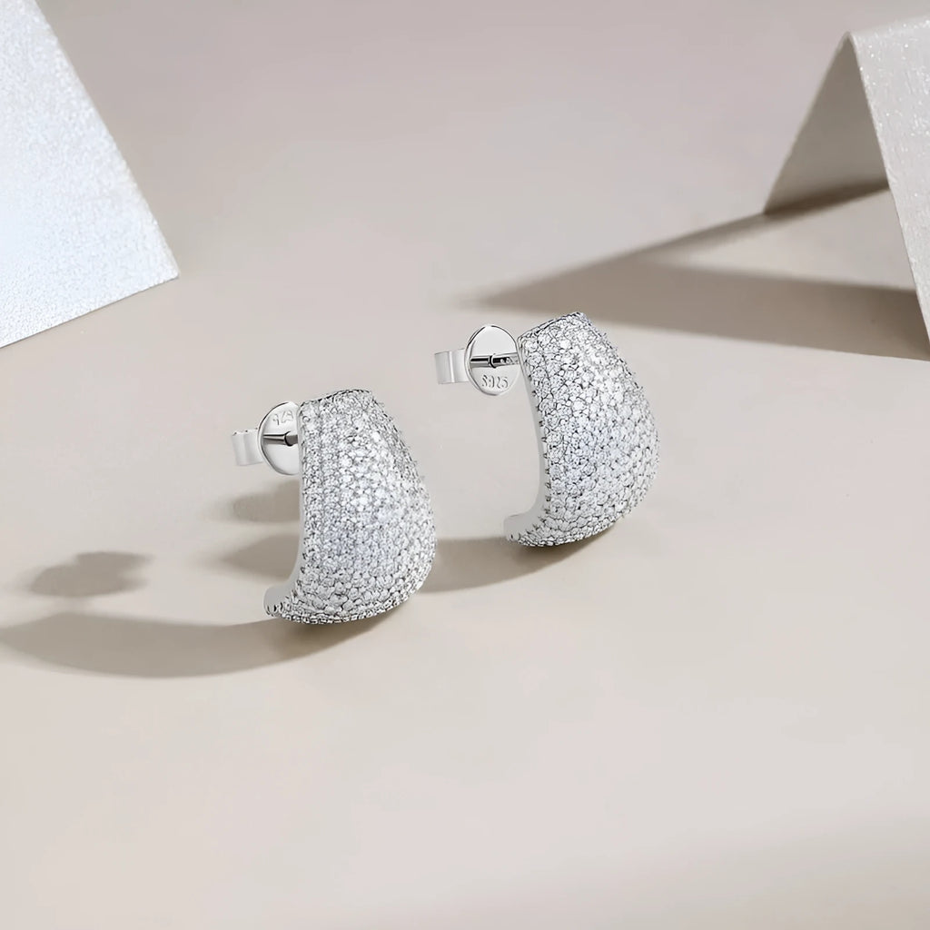 Geometric S925 sterling silver stud earrings with white moissanite stones on a gift box.