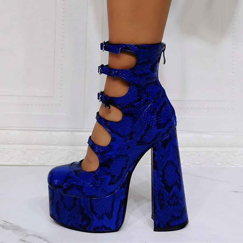 Black patent leather women's ankle boots with a platform, thick block heel, and a serpentine buckle strap around the ankle.