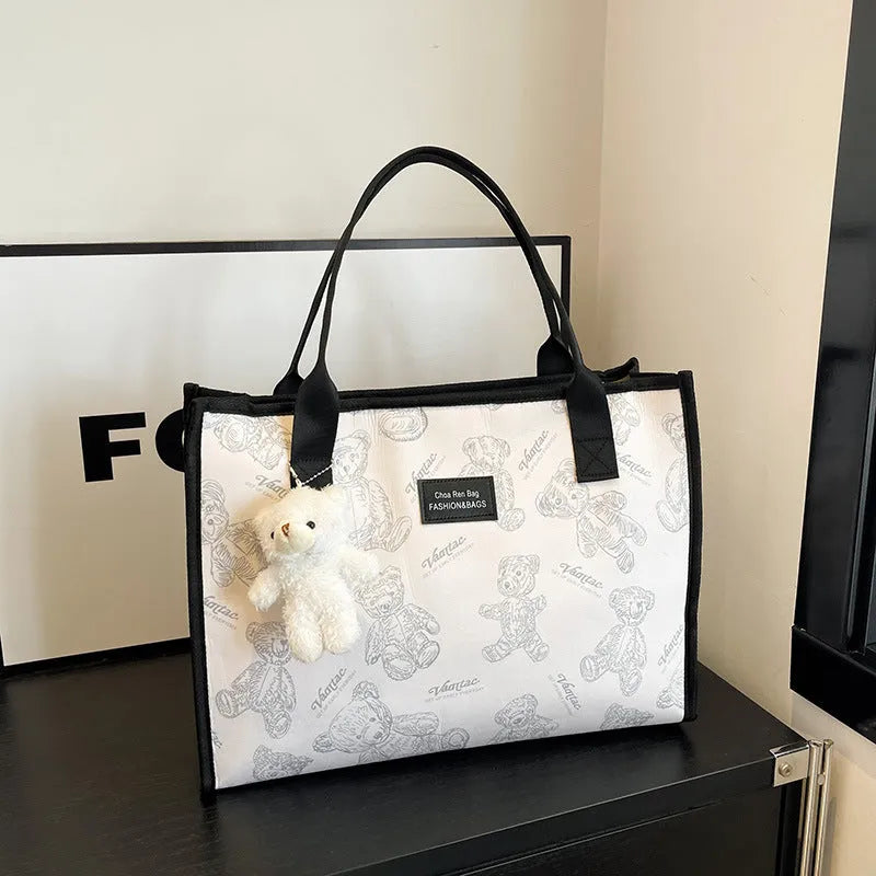Women's black and white canvas tote bag with rhombus pattern and sandwich pocket design