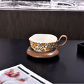 Antique ceramic coffee cup and saucer set in black or orange with medieval fruit design