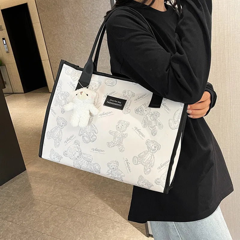 Women's black and white canvas tote bag with rhombus pattern and sandwich pocket design