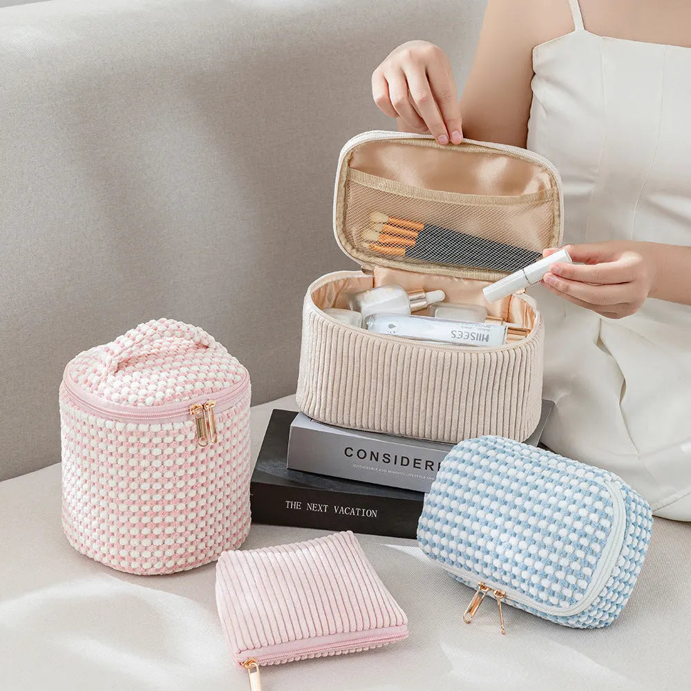 Four cube-style polyester makeup bags in pink, khaki, pink dots, and blue with dots colour options