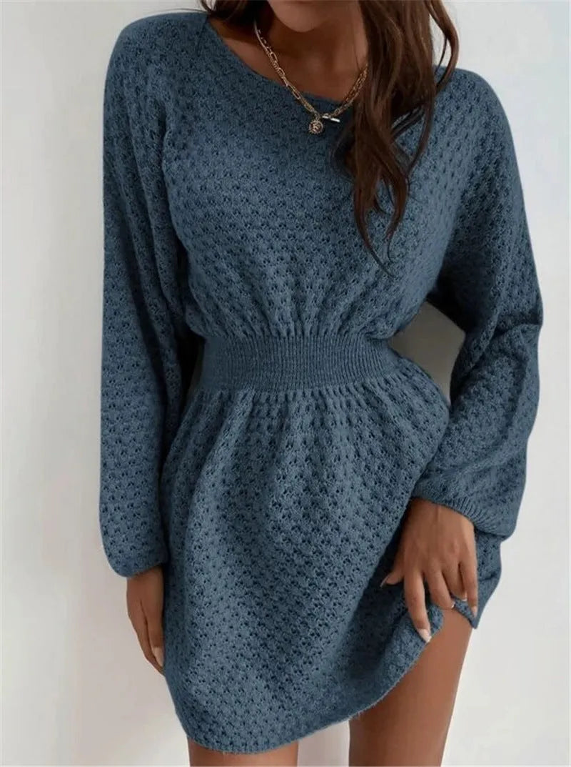 Blue women's knitted dress with hand-crocheted white flowers, a fitted waist, and a round neck.