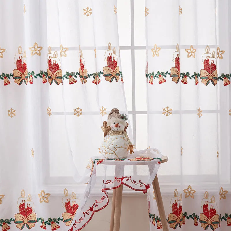 Pair of white Christmas curtains with detailed embroidered red and green snowflake design, showing texture and semi-sunshade fabric.