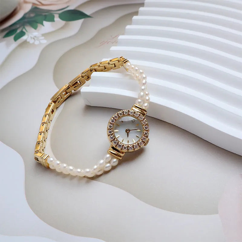 Women's light gold freshwater pearl bracelet watch with round dial and stainless steel strap