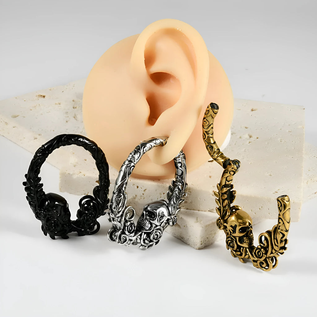 A pair of stainless steel totem pattern earrings with an electroplated finish, shown from the 15 available style options.