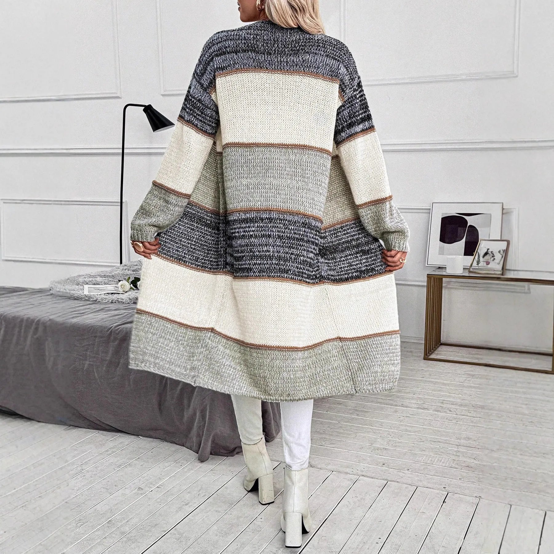 Grey knitted long cardigan with loose fit and long sleeves on a woman