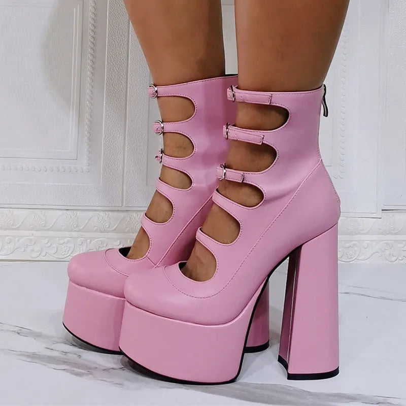 Black patent leather women's ankle boots with a platform, thick block heel, and a serpentine buckle strap around the ankle.
