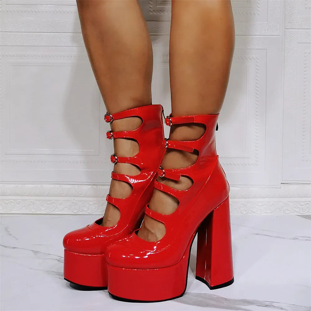 Black patent leather women's ankle boots with a platform, thick block heel, and a serpentine buckle strap around the ankle.