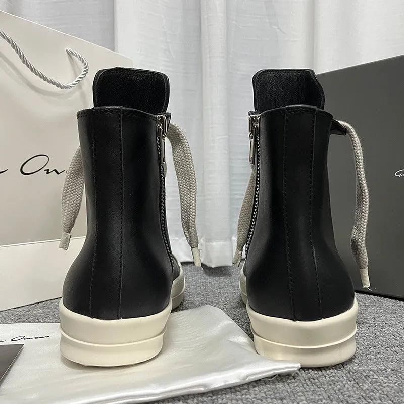 Black high-top leather sneakers with side zipper and platform sole on a white background