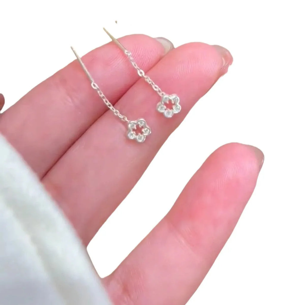 Silver flower hanging earrings with hollow petal design and stud backings