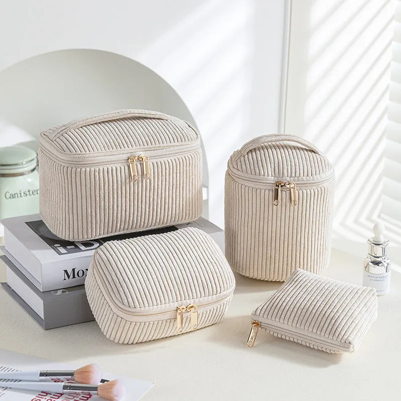 Four cube-style polyester makeup bags in pink, khaki, pink dots, and blue with dots colour options
