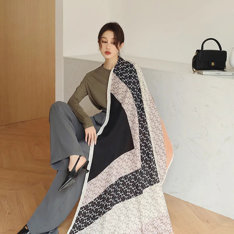 A woman wearing a printed polyester scarf, style 1, measuring 180cm by 90cm.