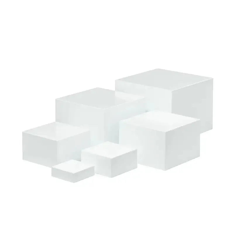 Six identical white plastic cube dessert display stands arranged together.