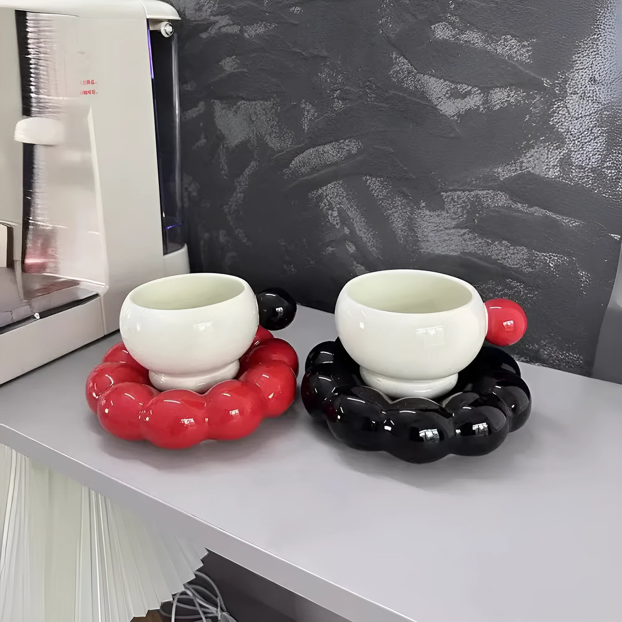 Ceramic coffee cup and saucer set in a simple solid colour, showing the 250ml cup resting on its matching dish.