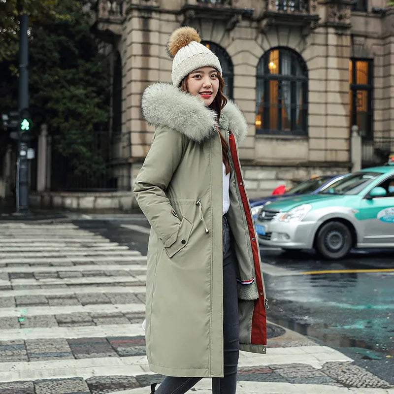Long beige women's trench coat with cotton-padded fleece construction on a hanger.