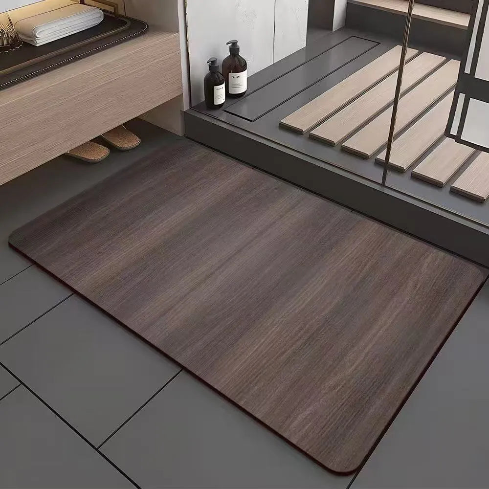 Square diatomite bathroom floor mat with wood grain geometric pattern in a bathroom setting.