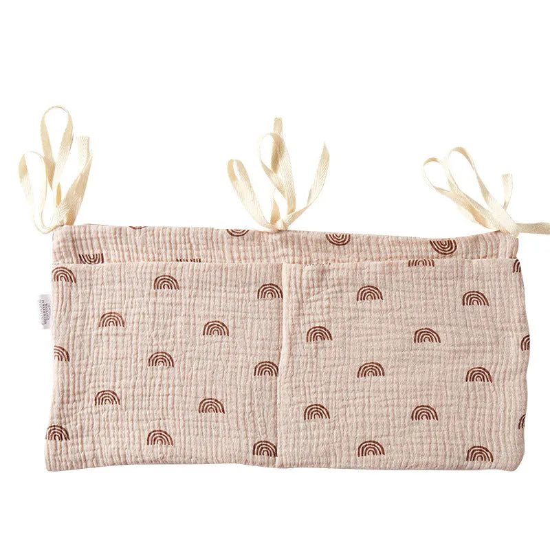 Cotton double layer baby bedside buggy bag in camel colour with tie straps attached to a pram handle